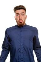 Attractive young man wearing blue shirt, isolated over a white background. photo