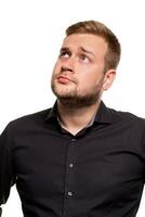 Young man wearing black shirt over isolated background thinking about question, pensive expression. photo