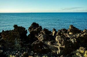 rock formations on the coast of the ocean photo