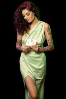 Attractive young female poker player holding pair of winning aces photo