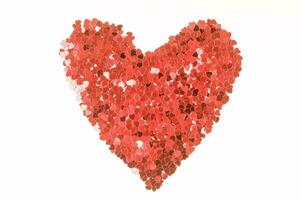 red heart confetti arranged in a heart shape photo