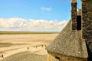 the view of the castle tower and people in the desert photo