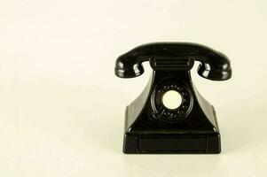 a black telephone on a white background photo