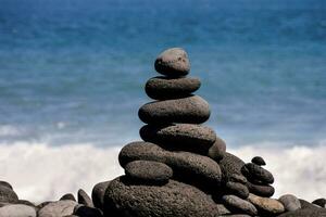 a stack of rocks is sitting on the beach photo