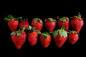 a group of strawberries on a black background photo