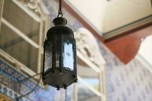 stained-glass wall lamp on a stone wall photo