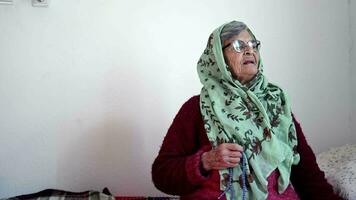 musulmán mayor mujer Orando en su cama en su habitación video