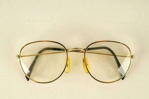 a pair of glasses with gold frames photo