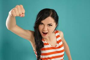 Studio photo of a gorgeous girl teenager posing over a blue background.