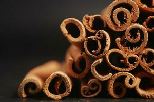 Cinnamon sticks against black background photo