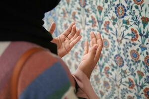 Muslim young woman in hijab is praying in mosque. photo