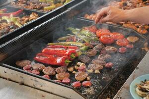 Beef and chicken steaks on the grill with flames. photo