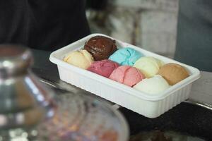 different flavor ice cream in a plastic container photo