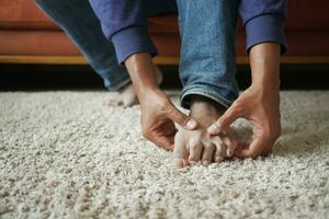 Close up on young man suffering feet pain photo