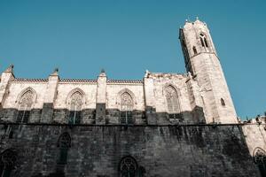 Cityscape photo of the Basilica of Saints Justus and Pastor, Barcelona. Beautiful photography with ornamental side wall.