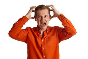 Close-up portrait of a ginger guy in orange shirt posing isolated on white background. Sincere emotions. photo