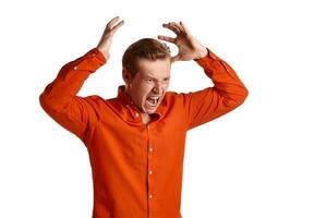 Close-up portrait of a ginger guy in orange shirt posing isolated on white background. Sincere emotions. photo