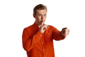 Close-up portrait of a ginger guy in orange shirt posing isolated on white background. Sincere emotions. photo