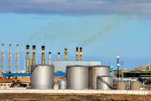 a factory with stacks of smoke coming out of it photo