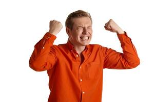 Close-up portrait of a ginger guy in orange shirt posing isolated on white background. Sincere emotions. photo