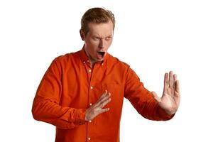 de cerca retrato de un jengibre chico en naranja camisa posando aislado en blanco antecedentes. sincero emociones foto