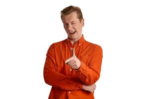 Close-up portrait of a ginger guy in orange shirt posing isolated on white background. Sincere emotions. photo