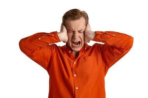 Close-up portrait of a ginger guy in orange shirt posing isolated on white background. Sincere emotions. photo