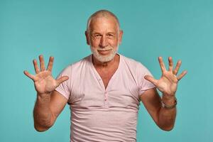 Handsome mature man posing against a blue studio background. photo