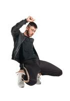 Full-length photo of a funny guy dancing in studio isolated on white background.