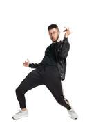 Full-length photo of a funny guy dancing in studio isolated on white background.