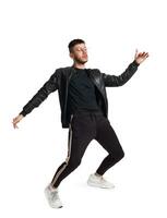 Full-length photo of a funny guy dancing in studio isolated on white background.