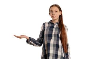 Beautiful teenage girl in a casual checkered shirt is posing isolated on white studio background. photo