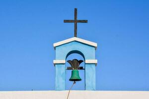 a green bell on top of a church photo