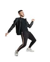 Full-length photo of a funny guy dancing in studio isolated on white background.