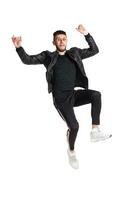 Full-length photo of a funny guy dancing in studio isolated on white background.