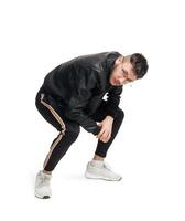 Full-length photo of a funny guy dancing in studio isolated on white background.