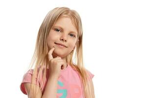 de cerca retrato de un bonito rubia pequeño niño en un rosado camiseta posando aislado en blanco antecedentes. foto