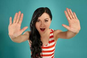 Close-up shot of a beautiful girl posing against a blue background. photo