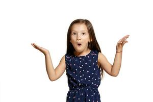 Close-up studio shot of beautiful brunette little girl posing isolated on white studio background. photo