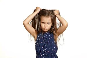 Close-up studio shot of beautiful brunette little girl posing isolated on white studio background. photo