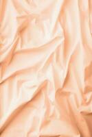 Color of the year 2024, Peach Fuzz. natural fabric linen texture for design photo