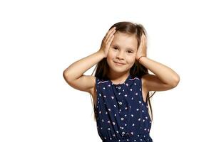 Close-up studio shot of beautiful brunette little girl posing isolated on white studio background. photo