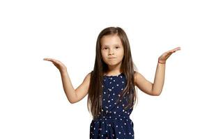 Close-up studio shot of beautiful brunette little girl posing isolated on white studio background. photo