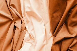 Color of the year 2024, Peach Fuzz. fabric texture background, three types of wavy fabric photo