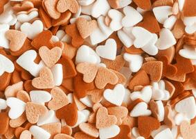 Color of the year 2024, Peach Fuzz.  heart shapes sprinkles background photo