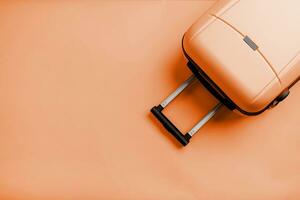 Color of the year 2024, Peach Fuzz.  Top view travel bag or suitcase on solid background copy space photo