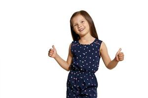 Close-up studio shot of beautiful brunette little girl posing isolated on white studio background. photo