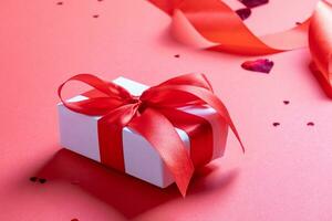 valentine red ribbons, confetti and gifts on red background photo
