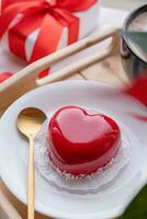 heart shaped glazed valentine cake in bed on wooden tray photo