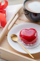 heart shaped glazed valentine cake in bed on wooden tray photo